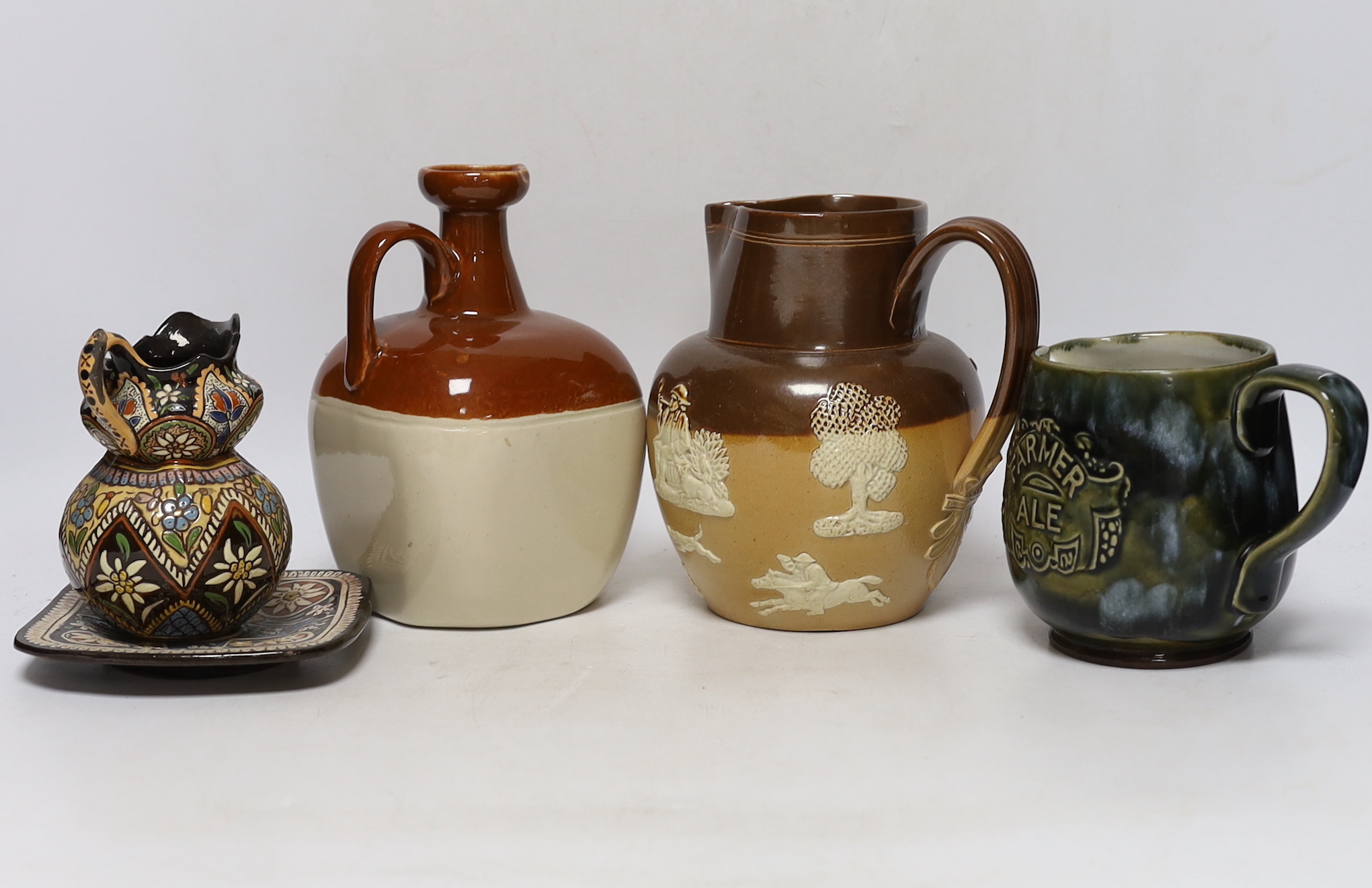 Three Thoune glazed earthenware items comprising dish, jug and vase, two signed to the base, the largest 12cm wide, Two Doulton stoneware jugs and a Long John whisky ewer, largest 17cm high